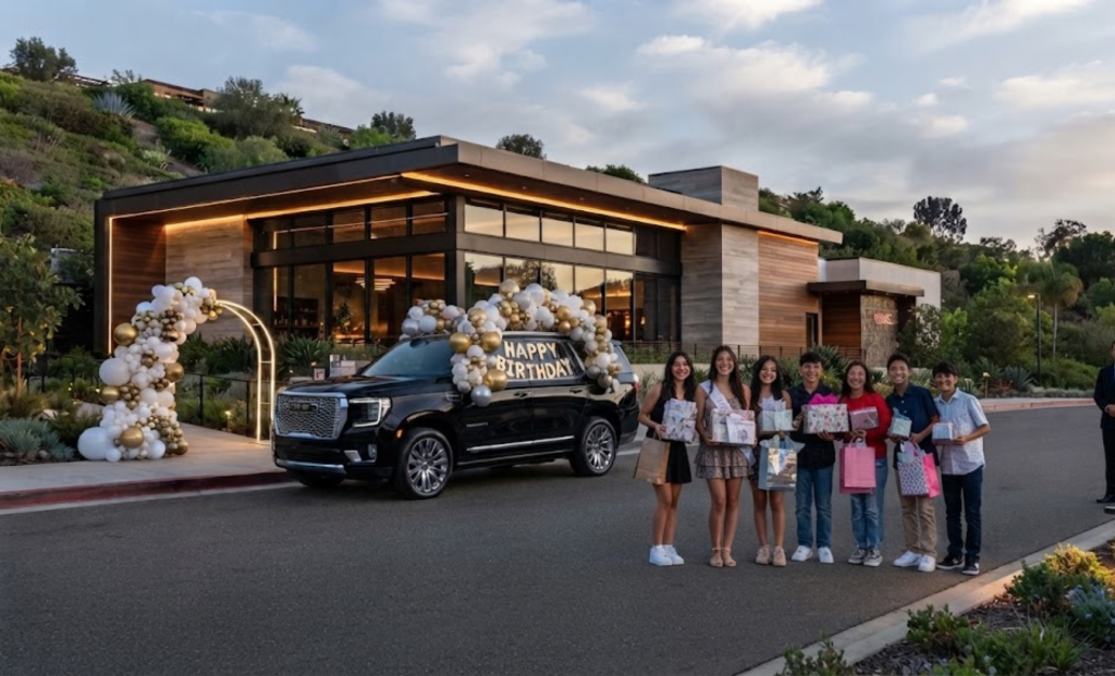 Birthday group in front of a balloon-decorated venue with a black SUV