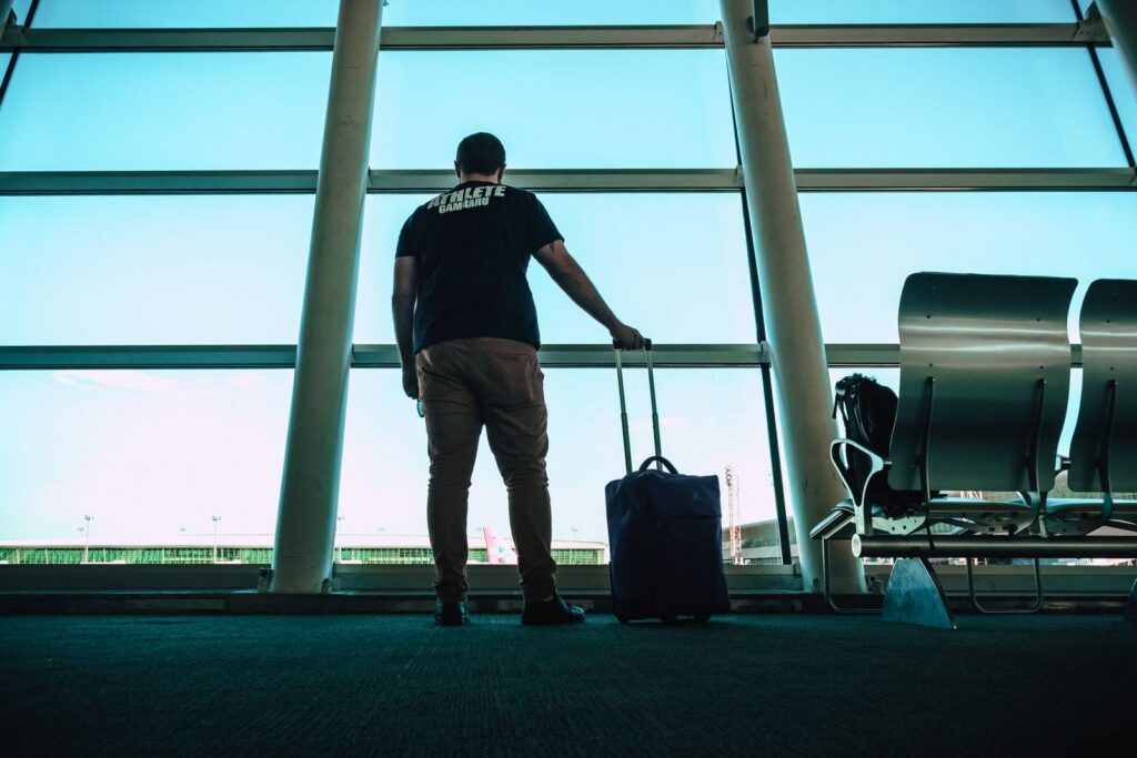 Traveler holding luggage ready for a Dallas Love Field car service pickup