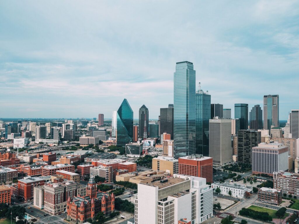 Aerial view of city buildings, airport limo service Irving business district