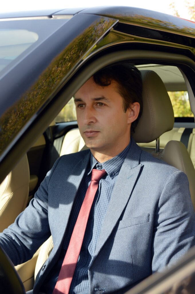 Well dressed businessman in a car, Irving and Las Colinas executive travel
