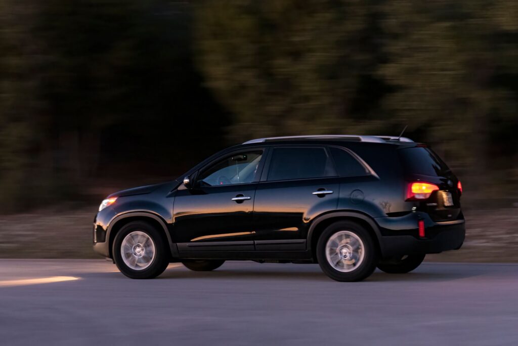Black SUV on the road for Addison Airport car service