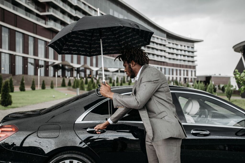 Chauffeur opening a car door for a passenger, Irving airport limo service